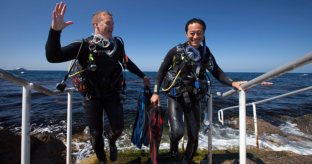 2 male divers coming up from dive