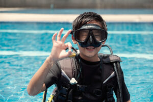 child in scuba gear in pool