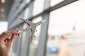 Close up hand holding an airplane model
