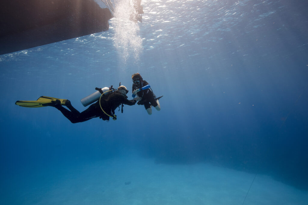father and son scuba diving together in cozumel