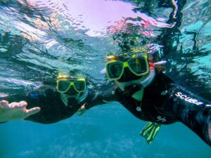 couple snorkeling in clear water