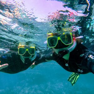 couple snorkeling in clear water