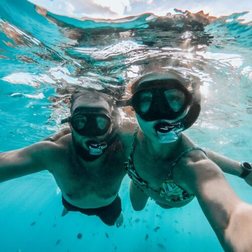 Couple snorkeling selfie Snorkelers exploring Cozumel's coral reefs with tropical fish